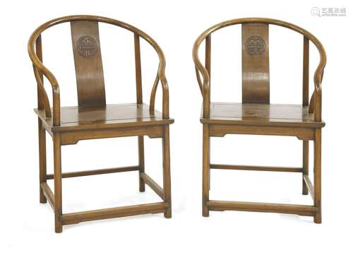 A pair of Chinese armchairs, early 20th century, each of classical form, with an horseshoe back and ...