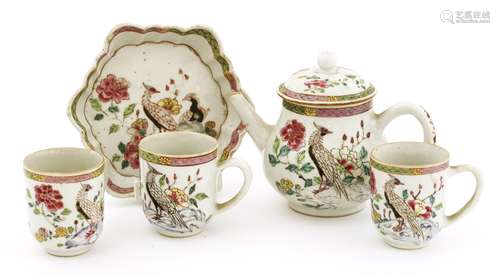 A Chinese famille rose tea set, Qianlong (1736-1795), comprising a teapot and cover on an hexagonal ...