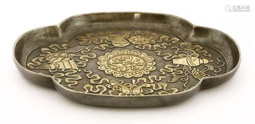 A Chinese silver dish, Qing dynasty (1644-1911), of quatrefoil form, engraved with the Eight ...