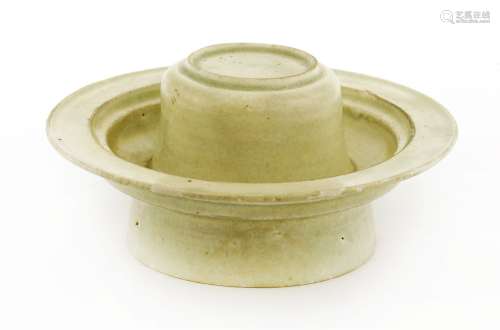 A Chinese qingbai ware cup stand, Song Dynasty (960-1279), of typical form covered with a light sea ...