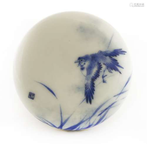 A Chinese blue and white box and cover,  of circular form, painted with a bird standing on the stem ...