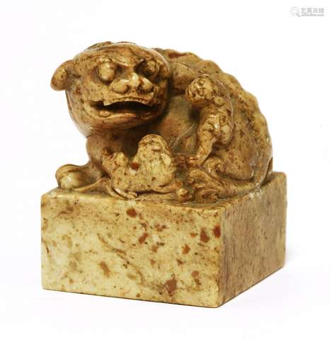 A Chinese soapstone seal, Qing dynasty (1644-1911), carved with a Buddhist lion with two pups ...