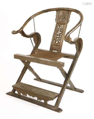 A Chinese folding armchair 20th century, the horseshoe-shaped rail with foliage, qilin and double ...