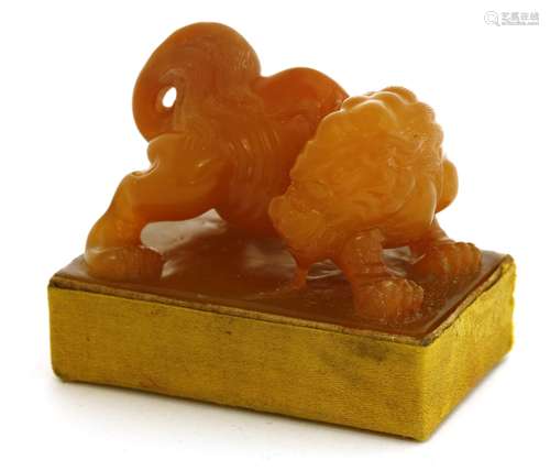 A Chinese soapstone seal, carved with a Buddhist lion standing on a rectangular plinth, 5.5cm wide  ...