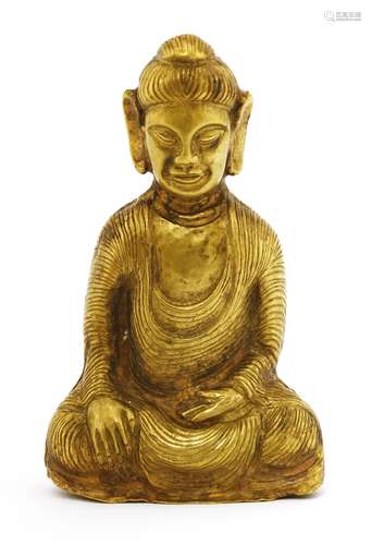 A South-East Asian gold Buddha, seated cross-legged in a long robe, with his hands in Bhumisparsa ...