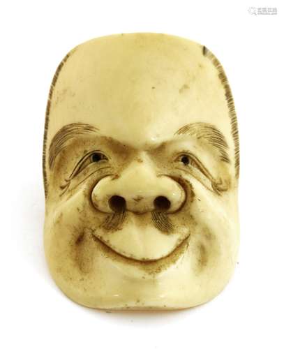 A Japanese ivory netsuke,Meiji period (1868-1912), of a theatrical mask of an old man,4.7cm long