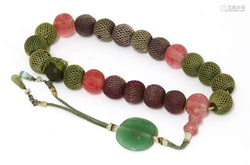 A Chinese bracelet,of eighteen wooden beads, in between four pink glass beads, 14cm long十八子手串