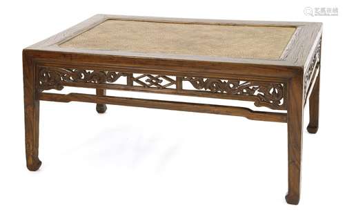 A Chinese yamu softwood rectangular low table, 19th century, with a rush matted top, the openwork ...