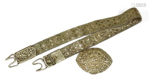 A Chinese silver belt, c.1900, finely worked with prunus against a brick ground, each end with a ...