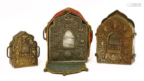 A Tibetan silver gau shrine, 19th century, of ogee arch shape, embossed with the Eight Buddhist ...