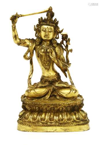 A Chinese bronze bodhisattva, seated cross-legged on a double lotus pedestal, wearing an elaborate ...