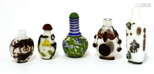 A collection of five Chinese Peking overlaid glass snuff bottles, three with bats, one with melons ...