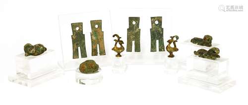 A collection of Chinese bronze artefacts, Han dynasty and later, comprising: three recumbent ...