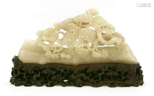 A Chinese jade carving, of peanuts and lingzhi growing from a section of bamboo,  33cm long, wood ...