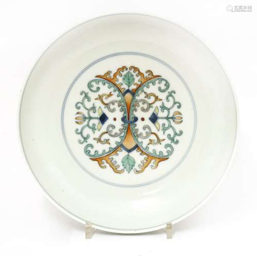 A Chinese doucai plate, painted with a symmetrical design with lotus, leaves and scrolls, the ...