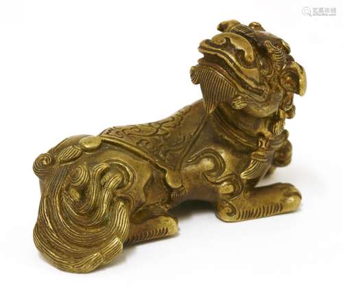 A Chinese bronze figure, of a recumbent Buddhist lion with an ornamental cloth engraved with lotus ...