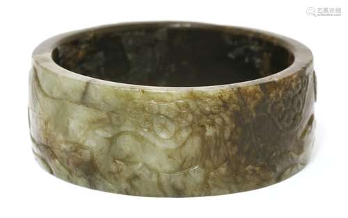 A Chinese jade bangle,  Ming dynasty (1368-1644), engraved with a recumbent buffalo under a pine ...