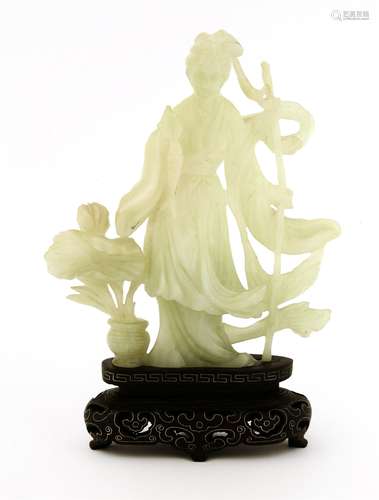 A Chinese jade carving, 1970s, of a fishergirl standing with a fish in her right hand, a vase with ...