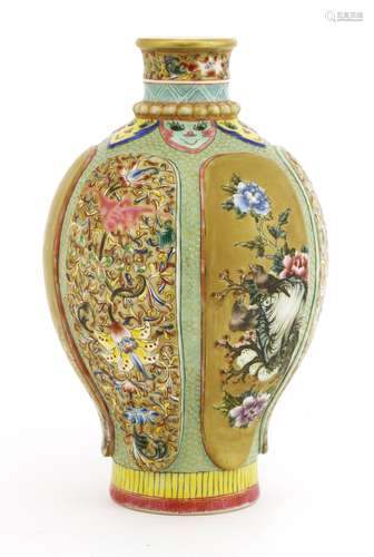 A Chinese famille rose vase, painted with birds and flowers against a gilt ground in shaped panels ...