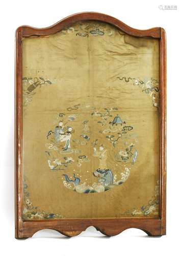 An embroidered fire screen, 19th century, of an embroidery of a male figure standing on the head of ...