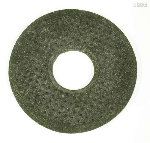 A Chinese liuli bi disc, Han dynasty (206 BC - AD 220), of circular form with archaic studs in ...