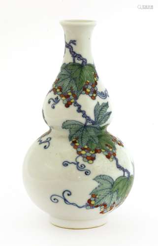 A Chinese doucai vase, Republic period (1912-1949), in a double gourd form painted with fruiting ...