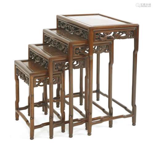 A Chinese nest of tables, 19th century, each of rectangular form over a pierced and carved apron of ...