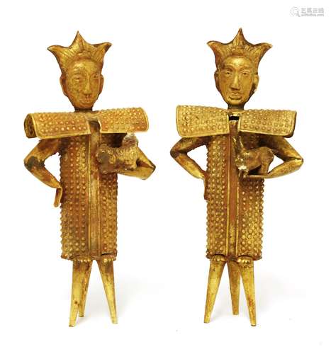 A pair of Chinese gold figures, standing with full armour on three legs, each holds a rabbit or a ...