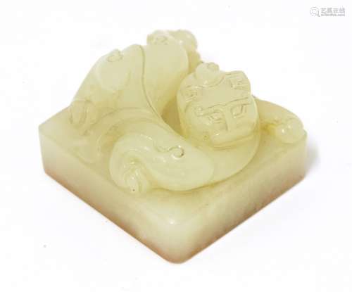 A Chinese jade seal, Qing dynasty (1644-1911), carved with a chilong lying on a square plinth ...