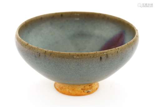 A Chinese Jun ware tea bowl, possibly Yuan dynasty (1279-1368), of tapering form with an inverted ...