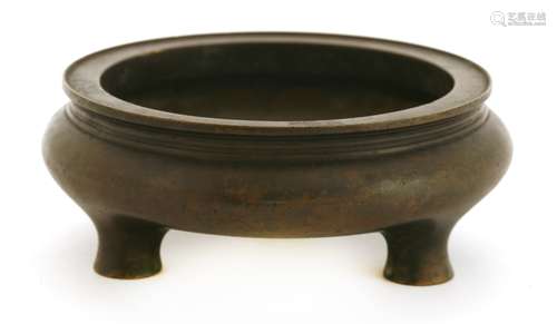 A Chinese bronze censer, of squat circular form on three feet, stamped mark Qingde Tang, 13cm ...