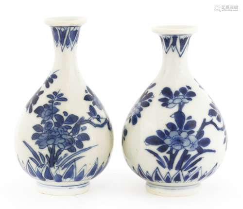 Two Chinese porcelain blue and white vases, Kangxi (1662-1722), each of pear shape with a tall ...