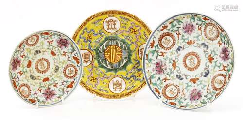 Three Chinese famille rose plates, late Qing dynasty, one with a shou roundel surrounded by clouds ...