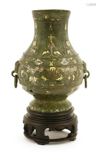 A Chinese bronze vase, in the Han style, of globular form on a raised foot, decorated with ...