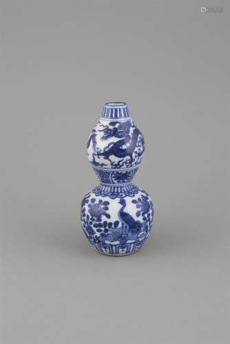 A BLUE AND WHITE DOUBLE GOURD VASE, WANLI (1573-1620) of traditional shape, the upper bulb painted