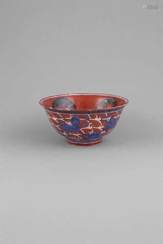 AN IRON RED AND UNDERGLAZE BLUE BOWL, probably Kangxi, of deep circular form, the interior centred