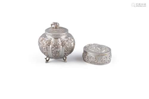 AN INDIAN WHITE METAL BOMBE SHAPED BOX AND COVER, late 19th century surmounted with an elephant, the