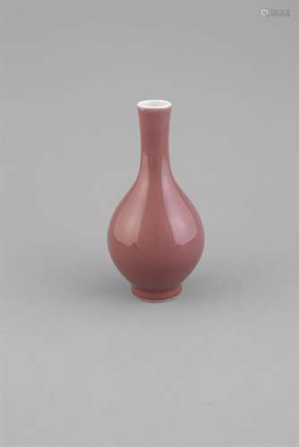 A COPPER RED MONOCHROME BOTTLE VASE, c.1800, of pear shape with consistant glaze and white tipped
