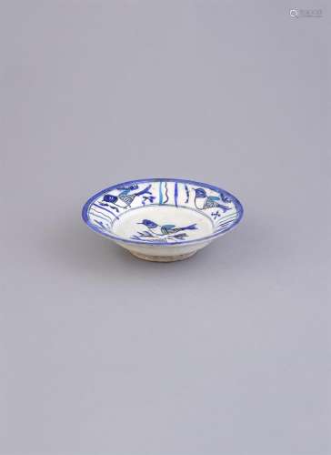 A PERSIAN BLUE AND WHITE GLAZED BIRD DISH, 18th century, with rounded sides and short foot, the