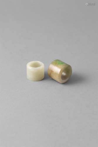 AN APPLE GREEN AND PALE JADE ARCHERS RING, Qing Dynasty (1644 - 1911/12); together with a Tibetan
