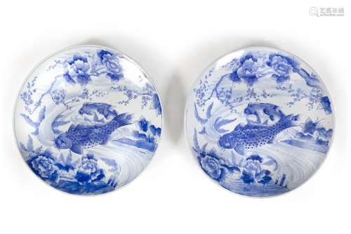 A PAIR OF 19TH CENTURY JAPANESEBLUE AND WHITE CHARGERS,each painted with leaping carp in a river