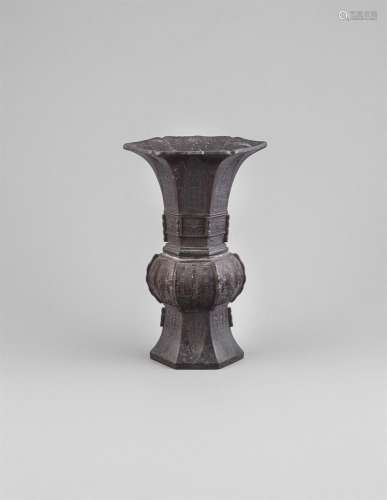 A MING BRONZE 'GU' VASE, 16/17th century, of hexagonal shape with flared neck pressed with pointed