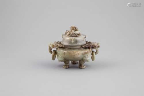 A MOTTLED JADE CENSER AND COVER, surmounted by a dragon head with loose ring handles on a compressed