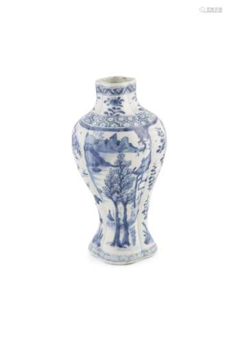 A BLUE AND WHITE RIBBED VASE, Qianlong (1736-1795), painted with pagodas within a river and mountain