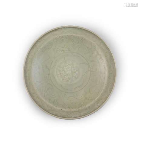 A LONGQUAN CELADON DISH, c.14/15th, of circular form with lipped rim, decorated with floral