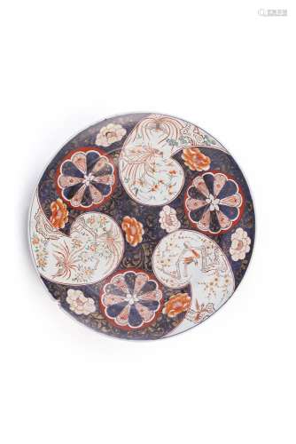 A LARGE IMARI PORCELAIN CHARGER, Arita 17th century, the blue ground with large mon medallions and