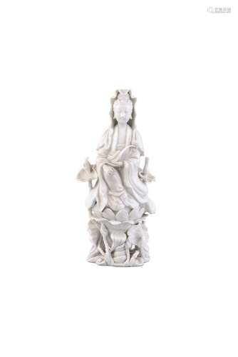 A BLANC DE CHINE MODEL OF GUANYIN, 18th century, depicted sitting on a lotus pod, with high