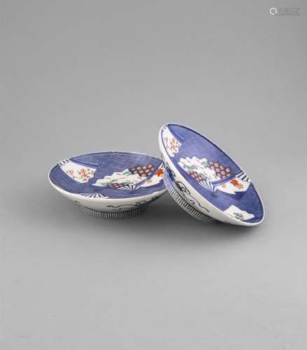 A PAIR OF NABESHIMA FOOTED DISHES, 19th century, of circular shape decorated in blue , iron red