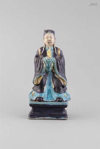 A TURQUOISE AND AUBERGINE GLAZED FIGURE OF A DAOIST IMMORTAL, 17th Century, modelled as an