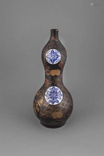 A LARGE PORCELAIN AND SIMIULATED LACQUER DOUBLE GOURD VASE, Meiji Period (1868 - 1912), the darkened